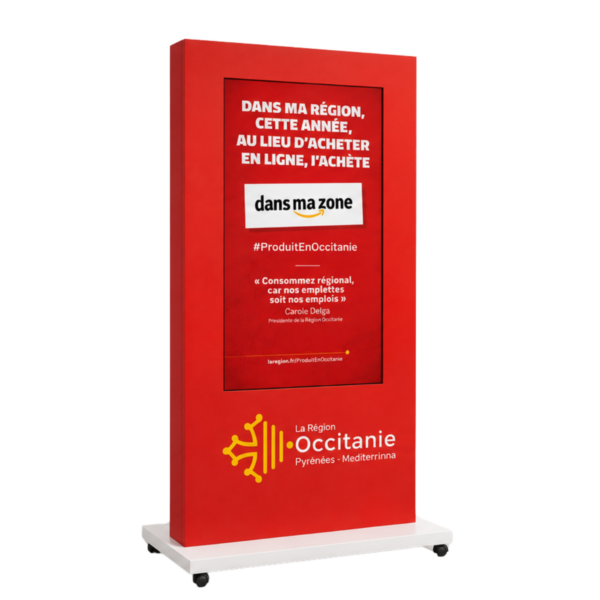 Red display panel promoting 'buy local' in Occitanie with the slogan 'dans ma région... j'achète' and the 'La Région Occitanie' logo at the bottom left.
