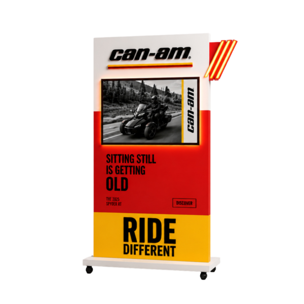 Can-Am promotional display with a mounted image of a motorcycle, bold red and yellow panels, and the slogan 'RIDE DIFFERENT' at the bottom.