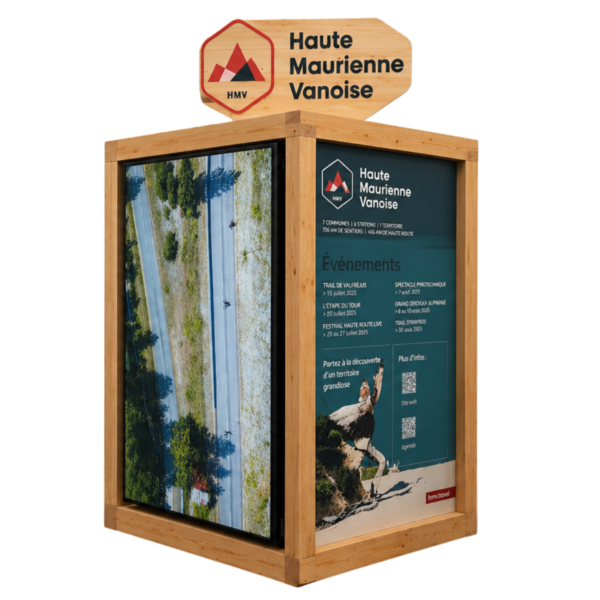Wood-framed information kiosk with a 'Haute Maurienne Vanoise' sign and teal event panels on the side.